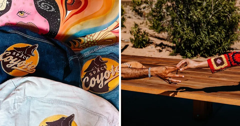 Hands meeting over a wooden table, with colorful cowboy hats and shirts in the background.