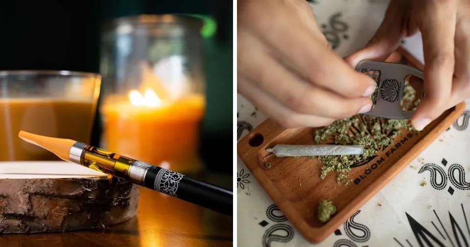 Candlelit smoking accessories: a lit joint, grinder, cannabis, and rolling paper on a tray.