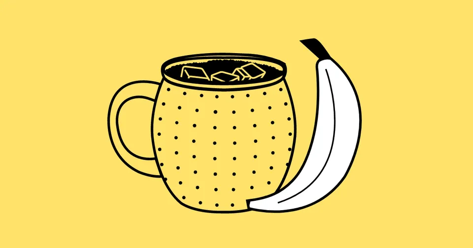 Yellow dotted mug with a handle, filled with coffee, beside a peeled banana on a yellow background