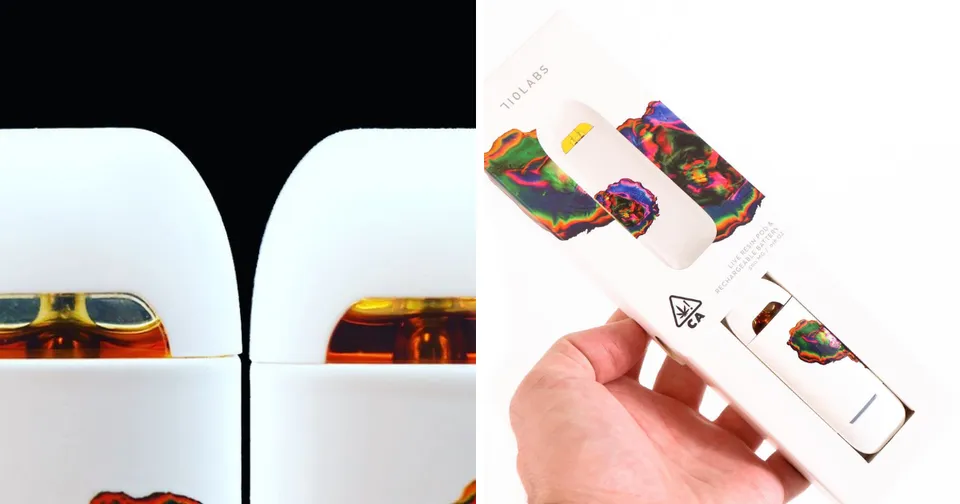 Hand holding white wired earbuds with colorful patterned cases on a black and white background