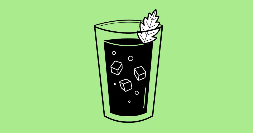 Tall glass of dark drink with ice cubes and mint on a light green background