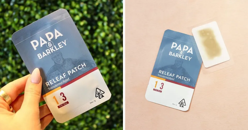 Two hands holding and displaying blue Papa Barley beverage cartons, one beside a small white cup.