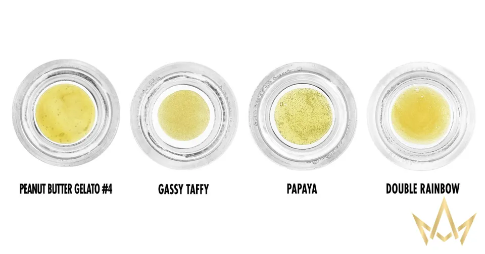 Four yellow glitter eyeshadows in open pots labeled Prawn Glitter Gold, Grassy Puff, Papaya, and Double Rainbow