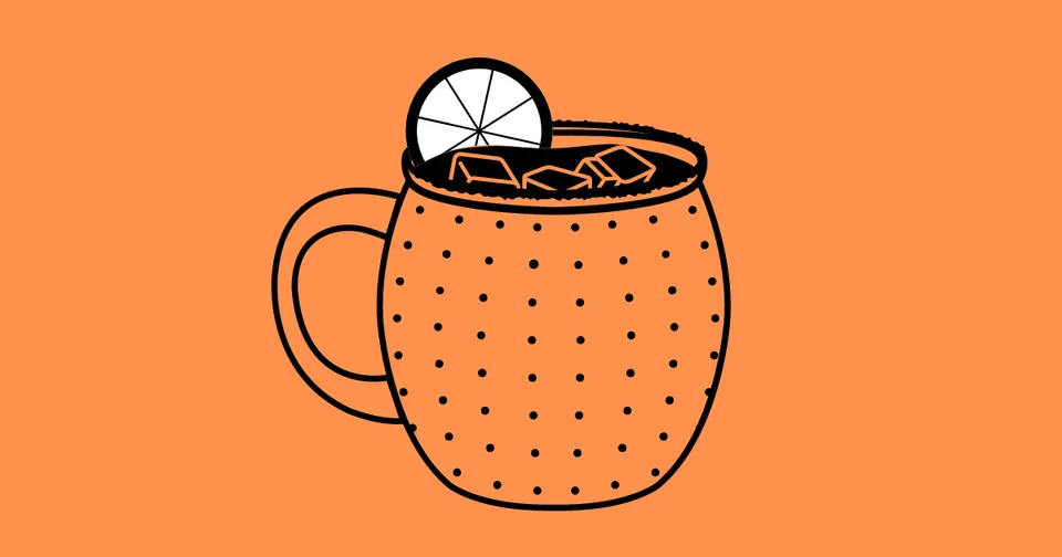 Orange mug with hot drink, whipped cream, and a lemon slice on a peach background