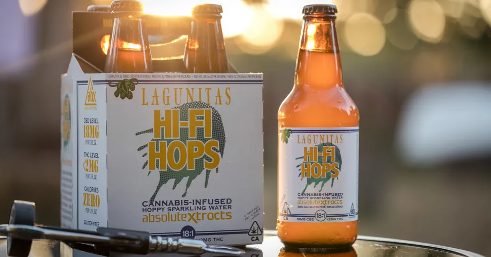 Lagunitas Hi Hops beer can and bottle on a table with warm sunset bokeh background