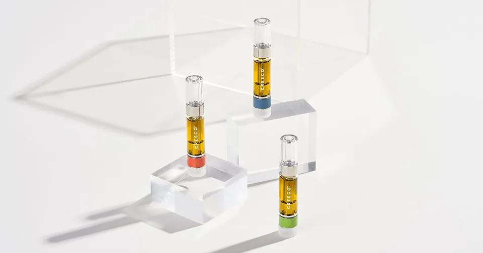 Three clear vials with yellow liquid arranged on a white laboratory device.