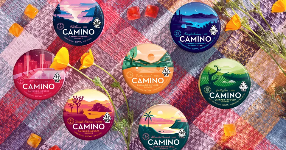 Colorful CAMINO snack cups arranged on a patterned woven textile backdrop.